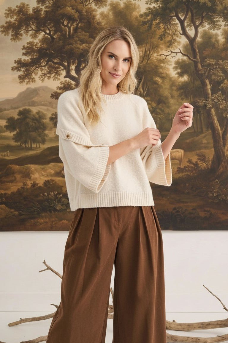 graced The Layla cream knit top with button-detailed sleeves worn by a blonde model in a relaxed fit