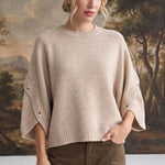 graced The Layla taupe knit top with button-detailed sleeves and a relaxed fit worn by a model