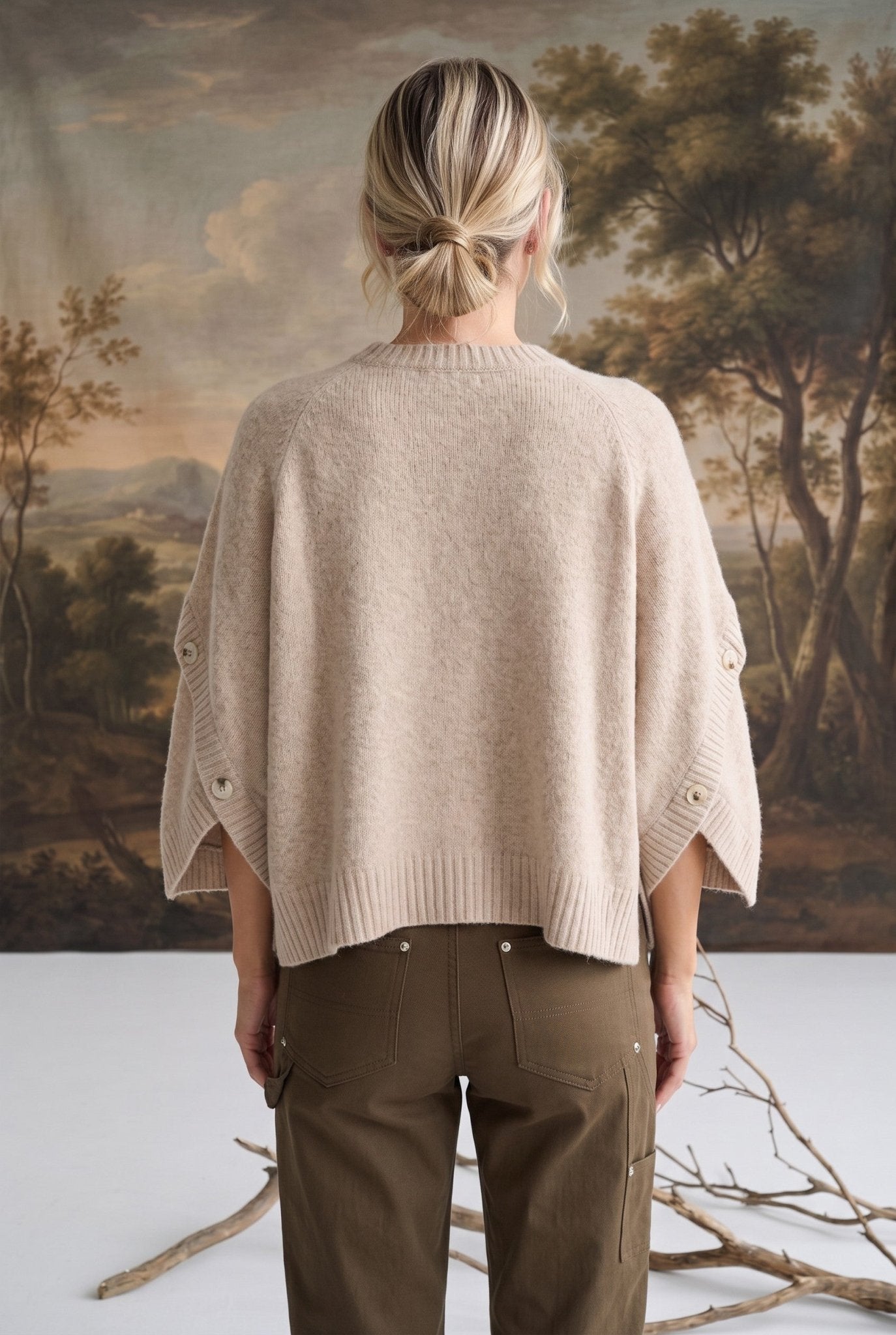 Back view of a model wearing the graced Layla taupe button sleeve top with a relaxed fit and ribbed hem