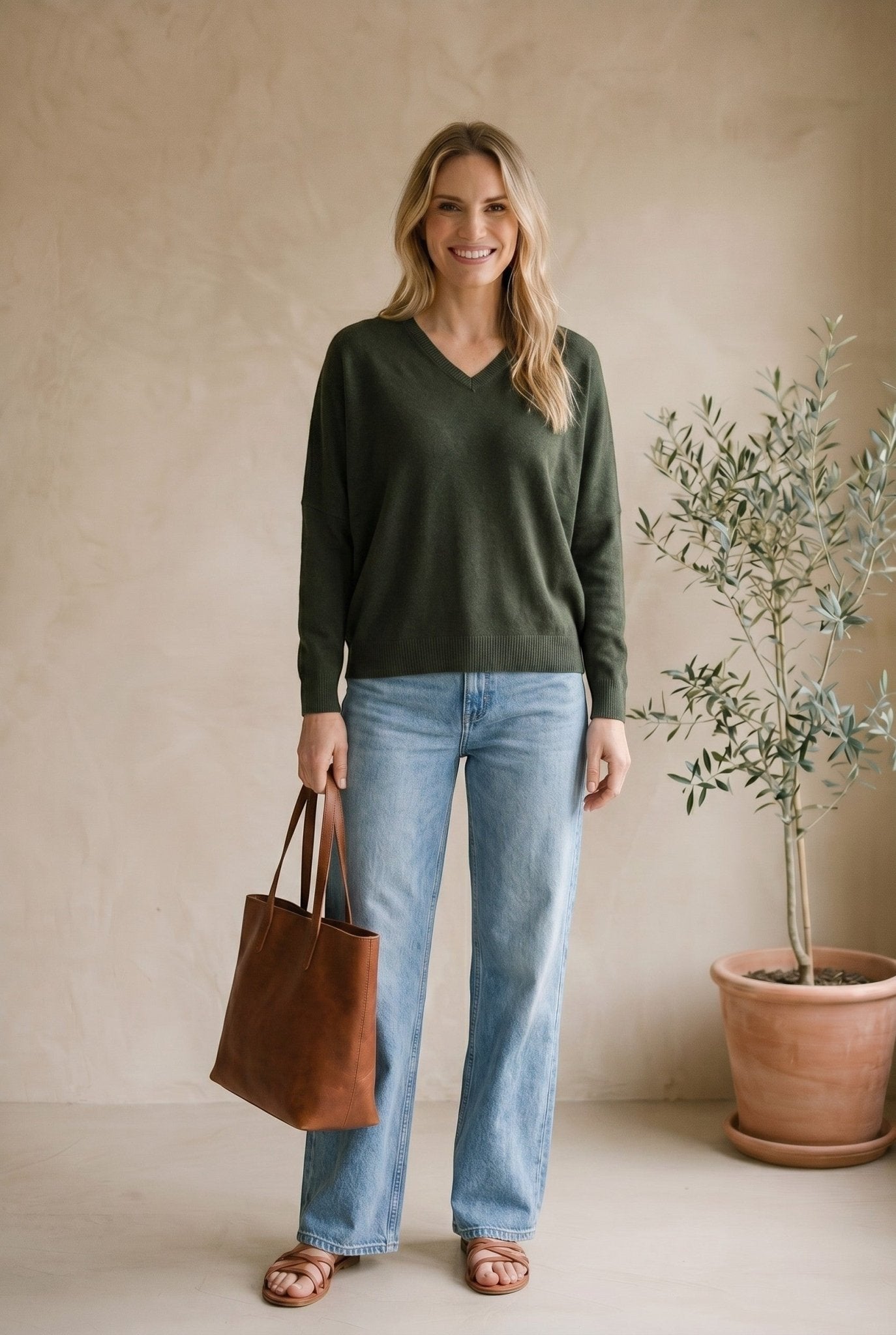 Dark olive Lyn super soft batwing V-neck sweater by graced, featuring a relaxed fit and cozy knit fabric.