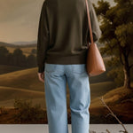 graced Lyn espresso batwing V-neck sweater worn with light wash jeans and a brown shoulder bag, back view