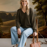 graced Lyn espresso brown V-neck sweater with batwing sleeves worn by a woman with light wash jeans and sandals