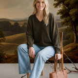 graced Lyn espresso brown V-neck sweater with batwing sleeves worn by a woman with light wash jeans and sandals
