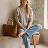 Taupe Graced Lyn super soft batwing V-neck sweater displayed on a hanger, showcasing its relaxed fit and cozy fabric.
