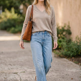 Taupe graced Lyn super soft batwing V-neck sweater displayed on a model, showcasing relaxed fit and cozy knit fabric.