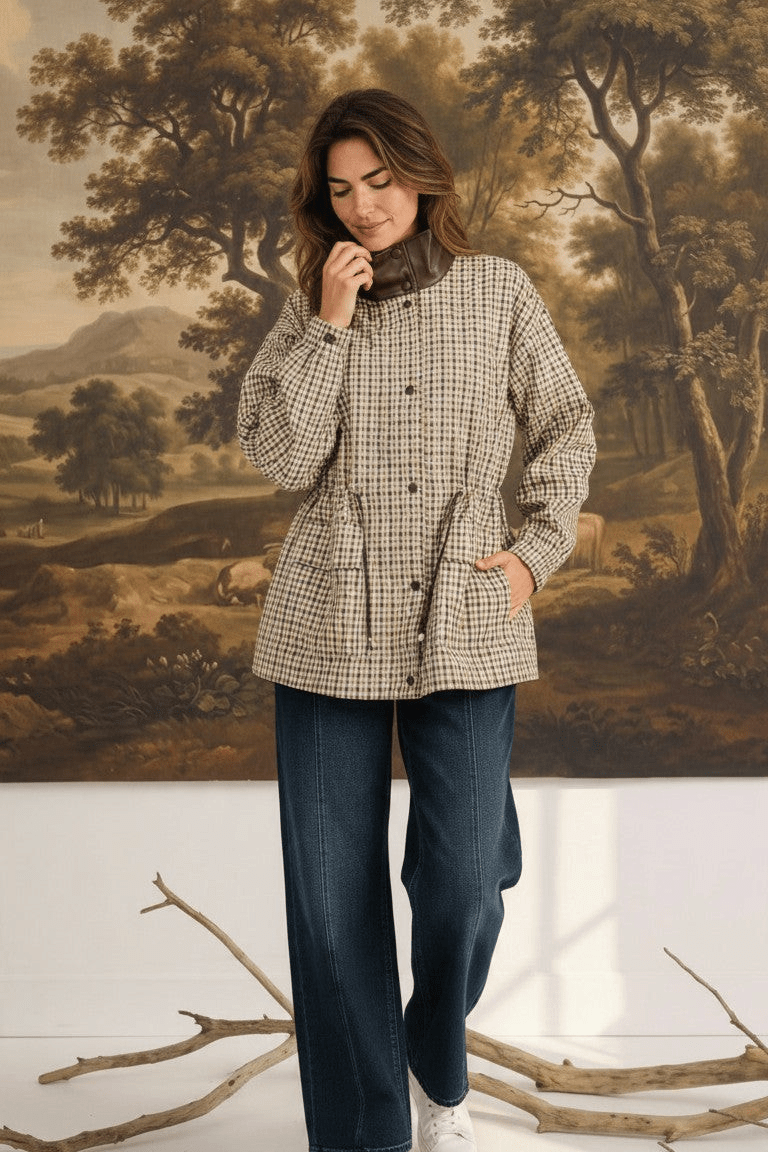 graced The Macy Mock Neck Jacket in a beige and brown plaid pattern with a dark brown collar, worn by a model.
