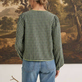 Back view of a woman wearing the graced Madilynne Gingham Top in green and black with long sleeves and lace trim.