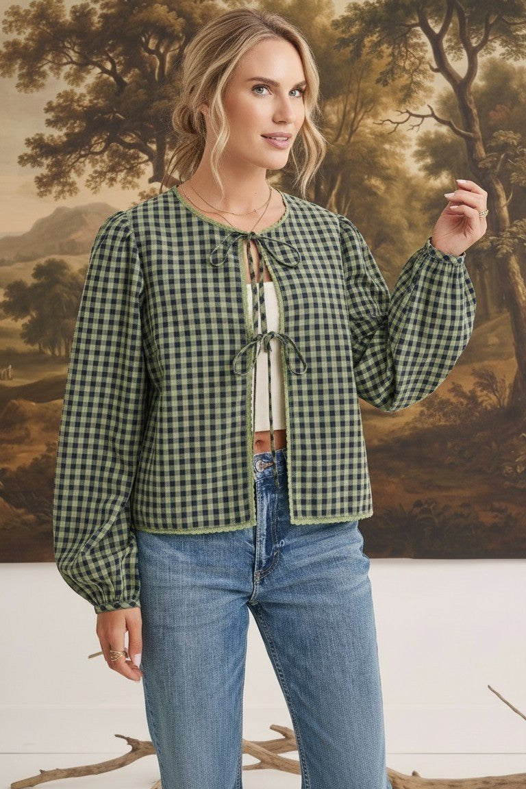 graced The Madilynne Gingham Top in green and black with long sleeves, lace trim, and a front tie closure.