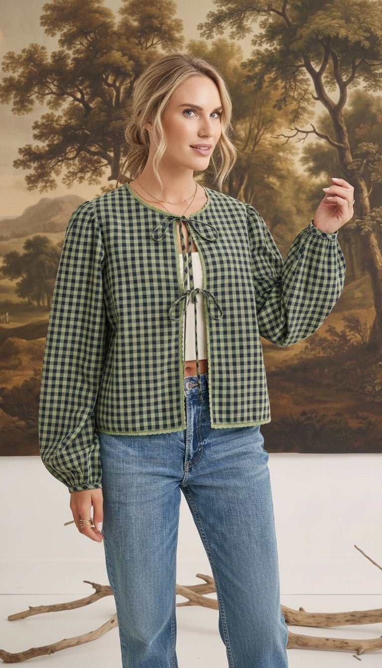 graced The Madilynne Gingham Top in green and black with long sleeves, lace trim, and a front tie closure.