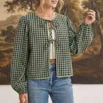 graced The Madilynne Gingham Top in green and black with long sleeves, lace trim, and a front tie closure.