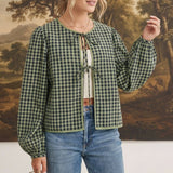 graced The Madilynne Gingham Top in green and black with long sleeves, lace trim, and a front tie closure.