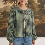 graced Madilynne Gingham Top in green and black with long sleeves, lace trim, and front tie closure on a model