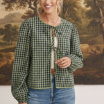 graced The Madilynne Gingham Top in green and black with long sleeves, lace trim, and a front tie closure on a model