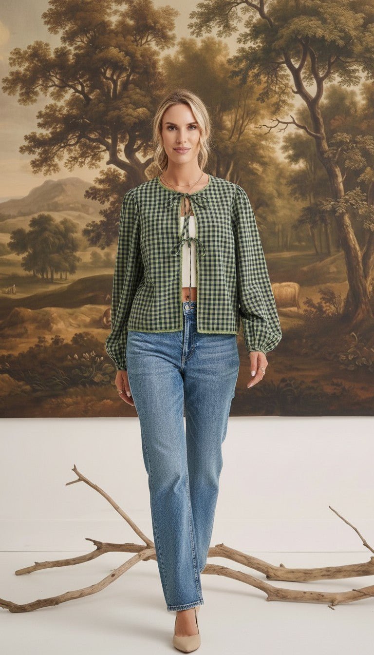 Model wearing graced Madilynne Gingham Top in green with long sleeves, lace trim, and a tie neckline over blue jeans