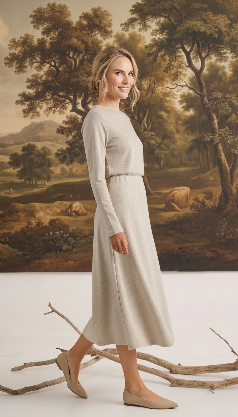 graced Margo wool midi skirt in beige worn by a blonde model with a long-sleeved top against a landscape painting