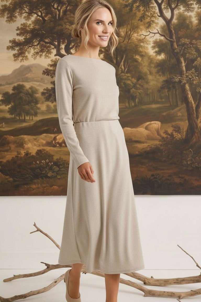 graced The Margo wool midi skirt in beige worn by a blonde model in a long-sleeved matching top against a landscape