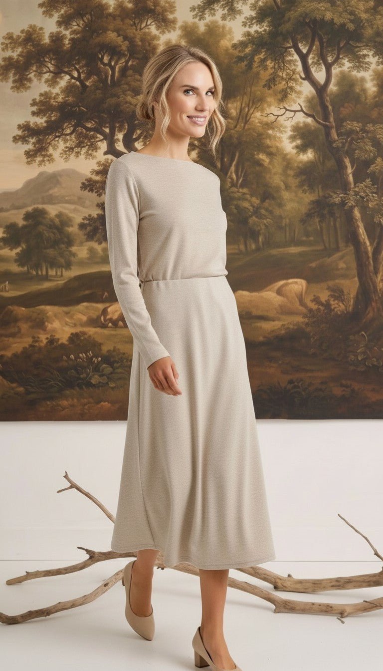 graced The Margo wool midi skirt in beige worn by a blonde model in a long-sleeved matching top against a landscape