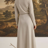 graced Margo midi skirt in beige wool blend worn by a woman with blonde hair in a bun, back view