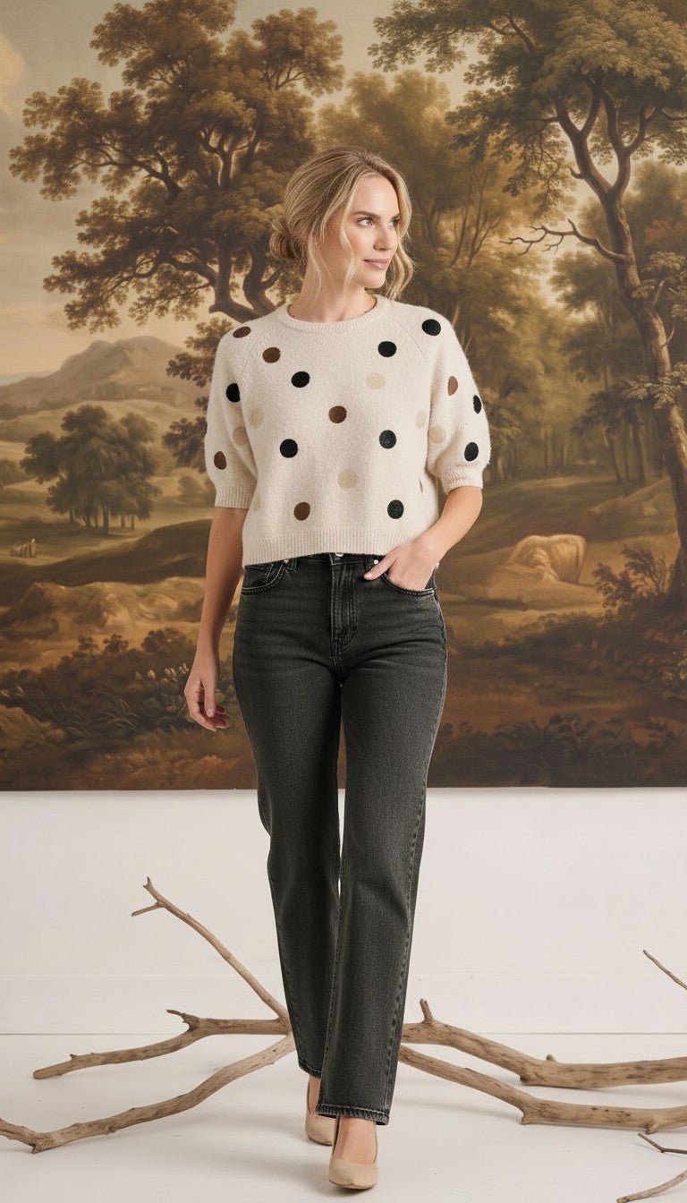 graced Michelle knit top in cream with multi-color polka dots, short sleeves, and relaxed fit worn with dark jeans.