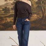 graced chocolate off the shoulder top with long sleeves worn by a blonde model with dark blue jeans