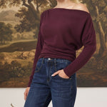 graced winetasting off the shoulder top with long sleeves worn by a blonde model with dark blue jeans