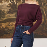 graced winetasting off the shoulder top with long sleeves worn by a blonde model with dark blue jeans