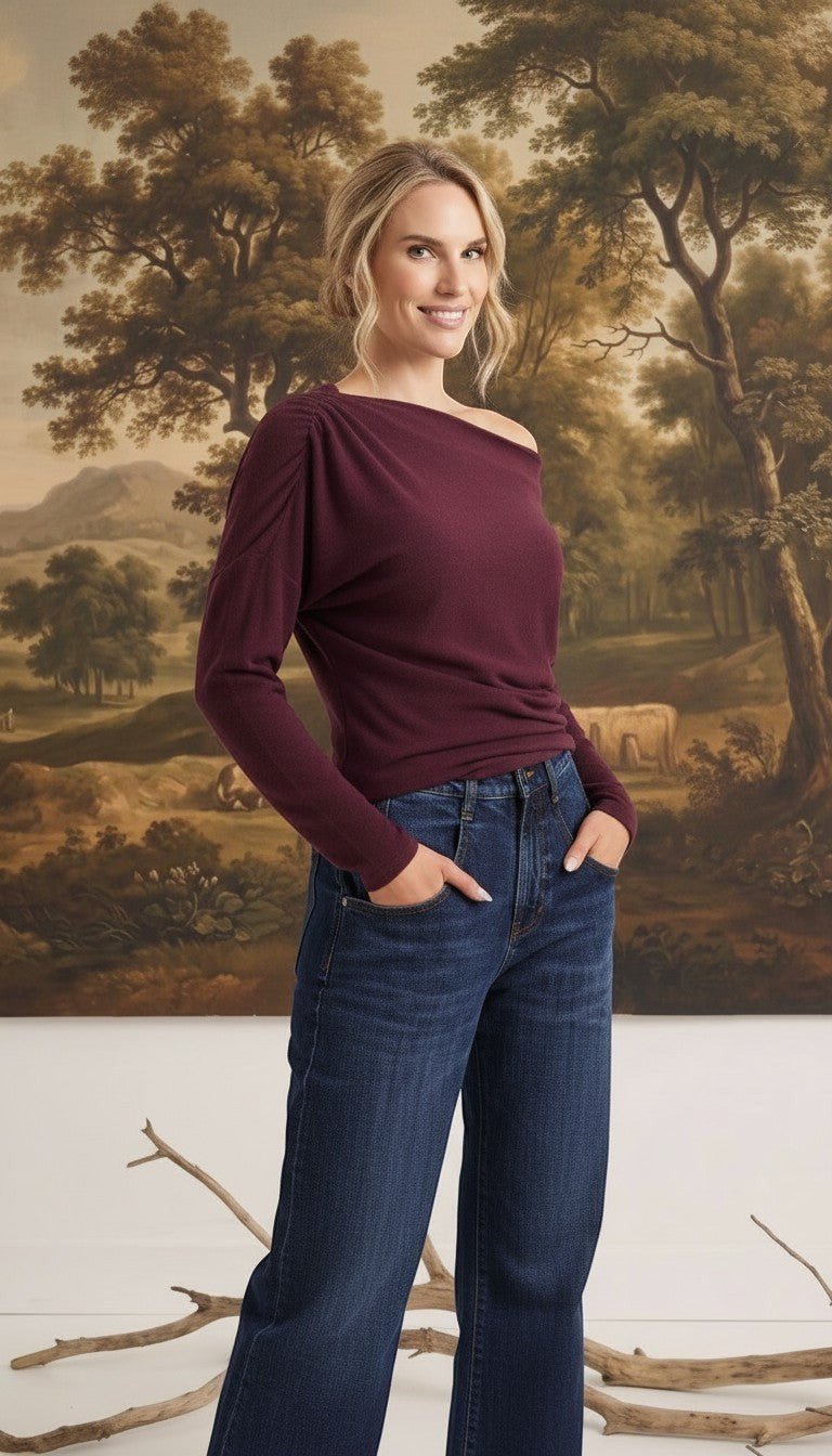graced winetasting off the shoulder top with long sleeves worn by a blonde model with dark blue jeans