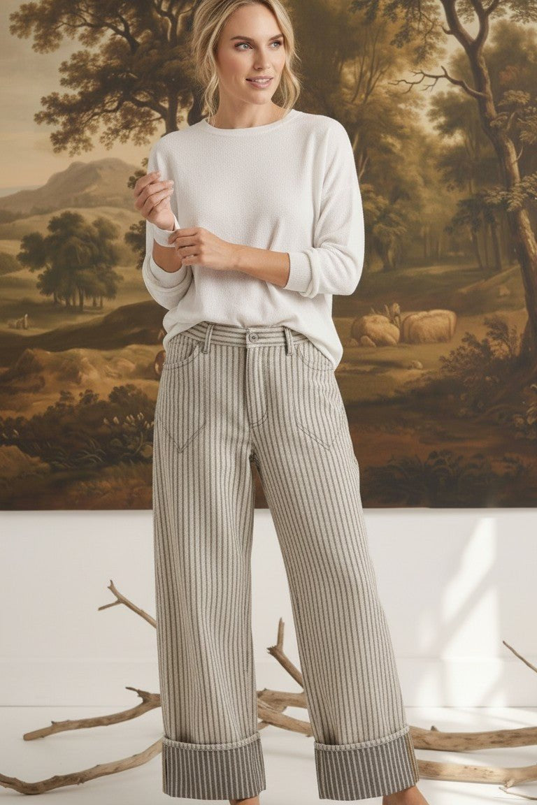 Model wearing graced Rae striped barrel pants in a relaxed fit with a white long-sleeve top and woven sandals.