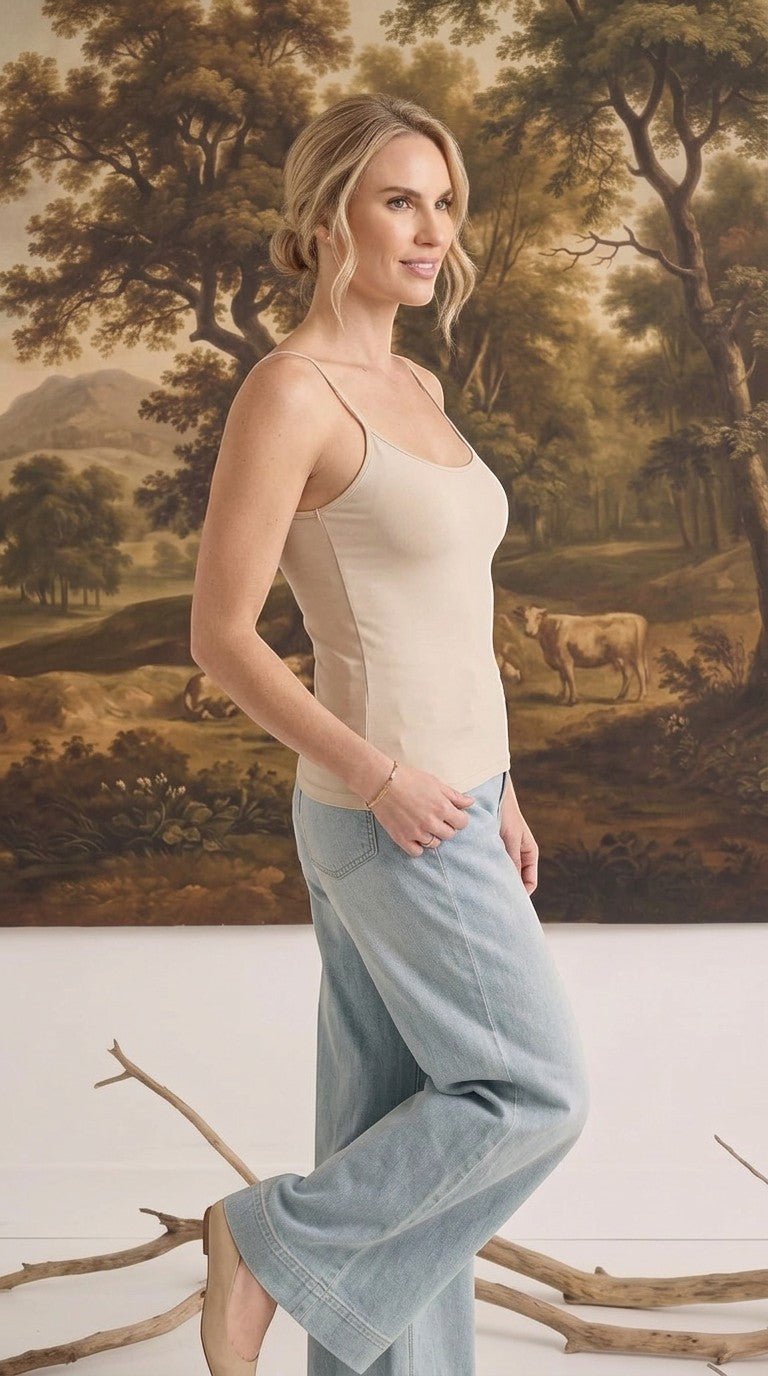 graced light taupe fitted cami with spaghetti straps worn by a woman with light blue jeans
