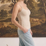 graced light taupe fitted cami with spaghetti straps worn by a woman with light blue jeans