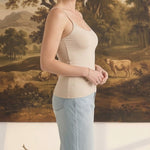 graced light taupe fitted cami with spaghetti straps worn by a woman with light blue jeans