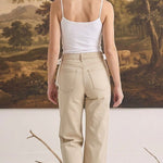 graced white fitted cami with spaghetti straps worn with beige denim jeans, viewed from the back