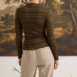 graced The Tatum chocolate brown long sleeve top with textured fabric and lettuce-edge hem worn by a woman