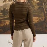 graced The Tatum chocolate brown long sleeve top with textured fabric and lettuce-edge hem worn by a woman