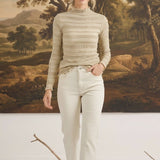 Model wearing graced The Tatum Lettuce Edge Top in oatmeal with textured fabric and feminine lettuce-edge detailing.