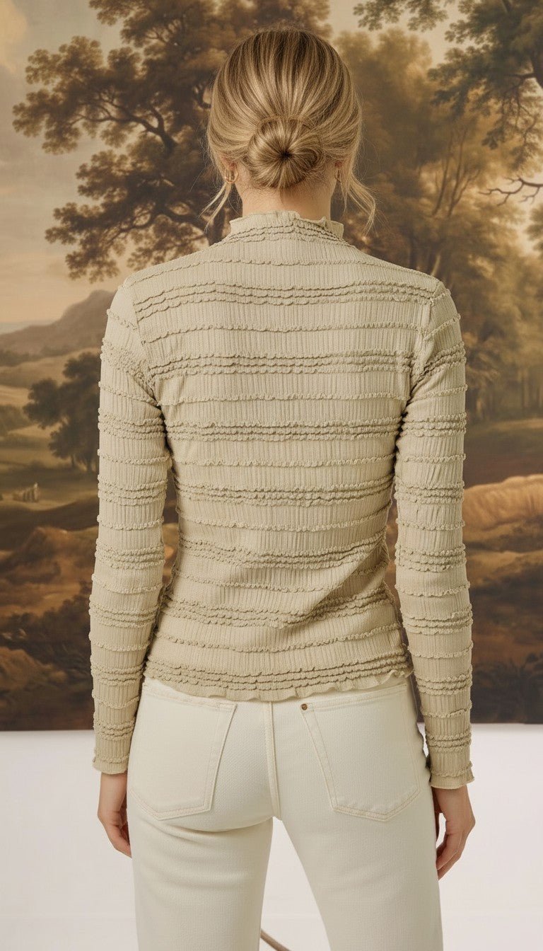 Back view of graced The Tatum Lettuce Edge Top in oatmeal featuring horizontal textured ruffles and long sleeves