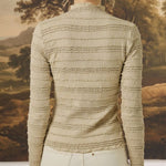 Back view of graced The Tatum Lettuce Edge Top in oatmeal featuring horizontal textured ruffles and long sleeves