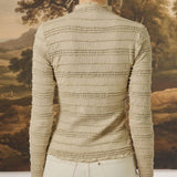 Back view of graced The Tatum Lettuce Edge Top in oatmeal featuring horizontal textured ruffles and long sleeves