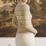 graced The Tatum oatmeal long-sleeve top with lettuce-edge trim worn by a model against a landscape painting backdrop