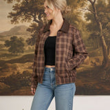 graced Tessa bomber jacket in brown plaid with leather collar, worn by a woman with jeans and a black top