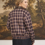 graced Tessa burgundy plaid bomber jacket with leather collar worn by a woman, back view