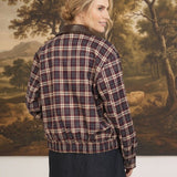 graced Tessa burgundy plaid bomber jacket with leather collar worn by a woman, back view