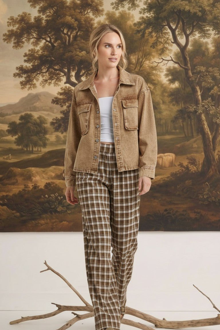 Model wearing graced The Tina Plaid Checker Pants in brown and white with a tan denim jacket in a studio setting.