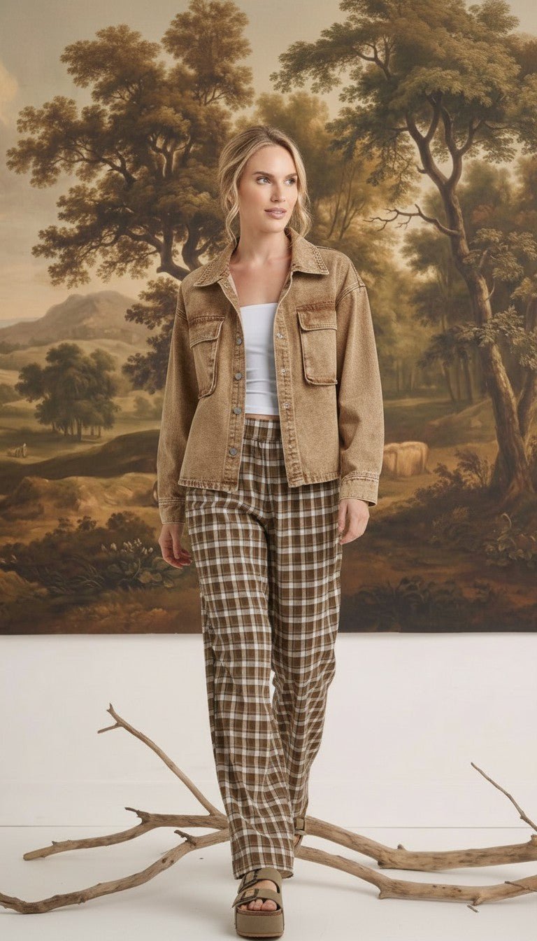 Model wearing graced The Tina Plaid Checker Pants in brown and white with a tan denim jacket in a studio setting.
