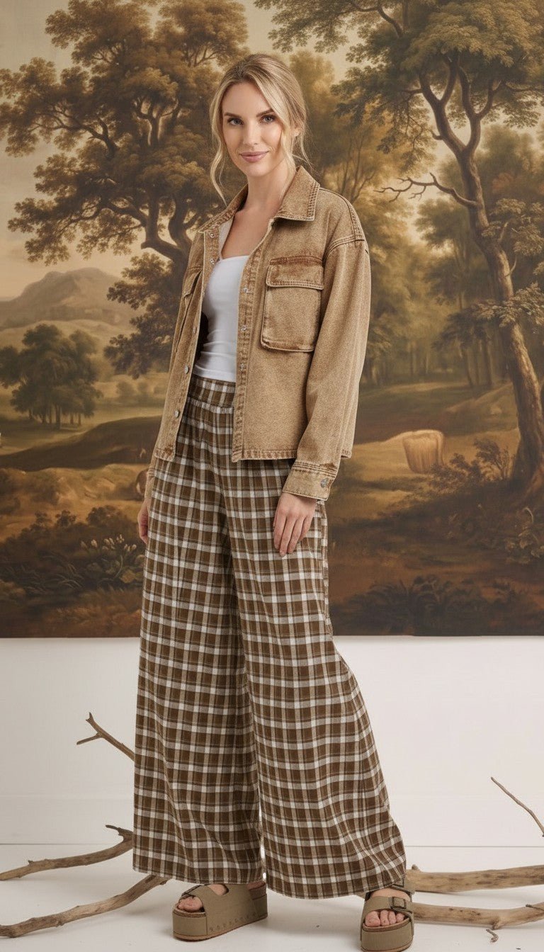graced model wearing brown and white plaid checker wide-leg pants with a tan denim jacket and platform sandals