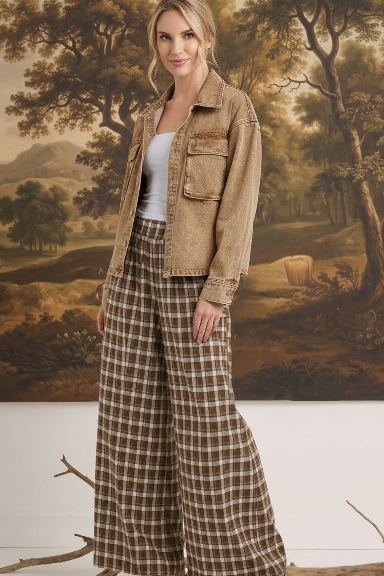 graced model wearing brown and white plaid checker wide-leg pants with a tan denim jacket and platform sandals