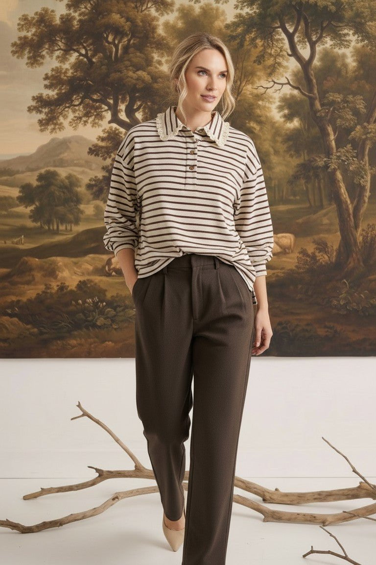 graced Tracy striped polo top with lace collar detail worn by a model with brown trousers in a studio setting