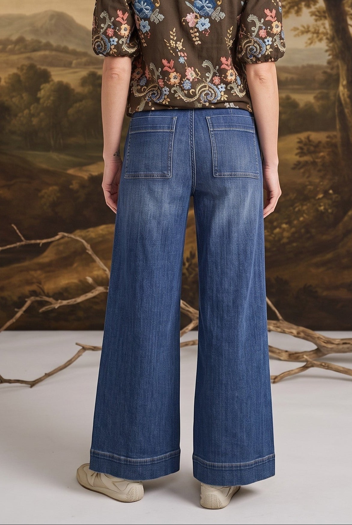 graced washed dark denim wide-leg pants with back pockets worn by a woman with a floral top